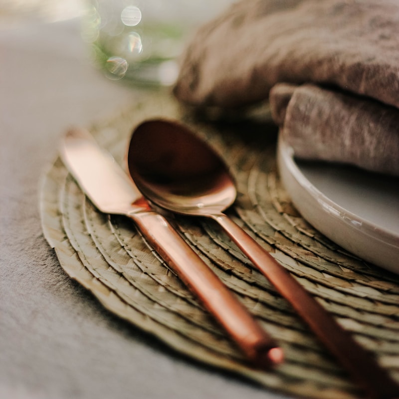 Copper cutlery on linen — table detail